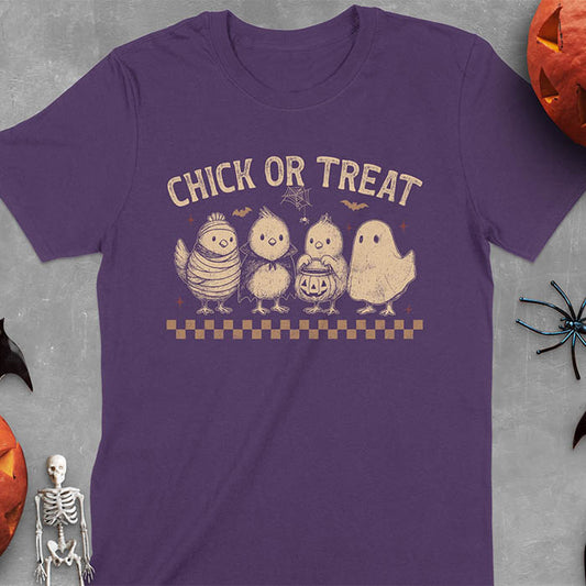 Purple t-shirt with Funny Halloween Chick Or Treat text featuring cartoon chickens dressed as spooky characters including ghost, mummy, vampire, and trick-or-treater