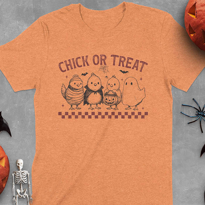 Heather Orange t-shirt with Funny Halloween Chick Or Treat text featuring cartoon chickens dressed as spooky characters including ghost, mummy, vampire, and trick-or-treater
