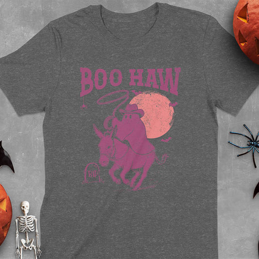 Dark heather t-shirt featuring cowboy ghost riding a donkey with lasso, 'BOO HAW' text above, red moon background with bats and RIP tombstone