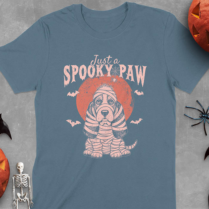 Indigo Blue t-shirt featuring cute basset hound wrapped in white mummy bandages with 'Just a SPOOKY PAW' text above
