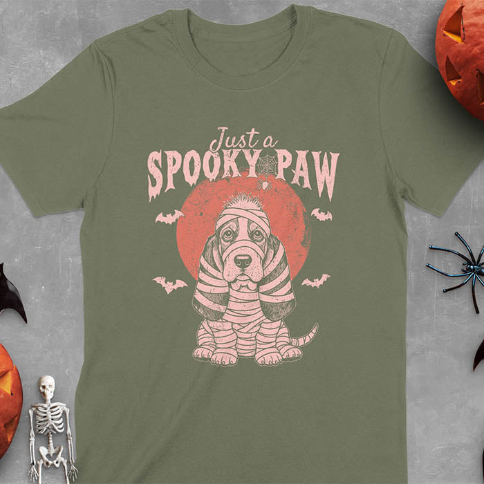 Military Green t-shirt featuring s cute basset hound wrapped in white mummy bandages with 'Just a SPOOKY PAW' text above