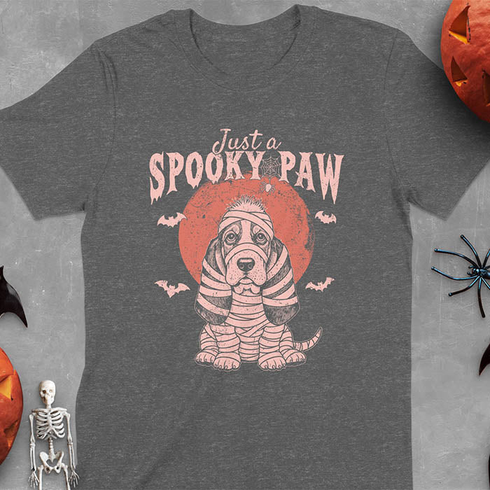 Dark heather t-shirt featuring a cute basset hound wrapped in white mummy bandages with 'Just a SPOOKY PAW' text above