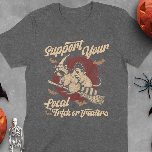 Dark heather t-shirt Halloween witch raccoon design featuring opossum pirate on broom with Support Your Local Trick or Treaters text