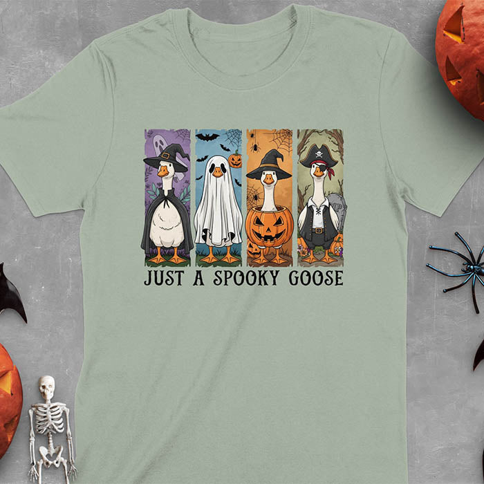 Sage green Halloween Just a Spooky Goose t-shirt featuring ghost, pumpkin, witch, and pirate goose designs