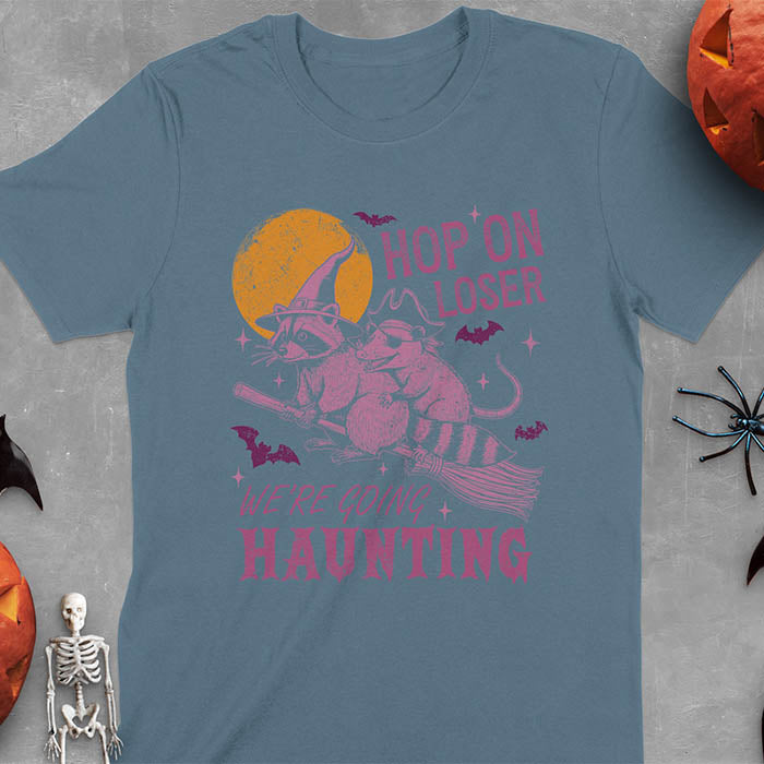 Indigo blue Halloween witch raccoon and opossum t-shirt with flying broom animal graphics