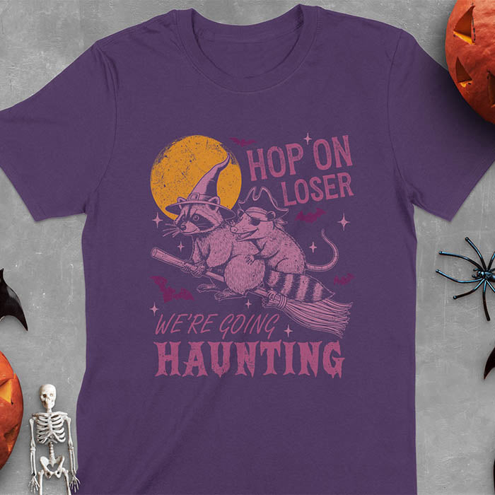 Purple Halloween witch raccoon and opossum t-shirt with flying broom animal graphics
