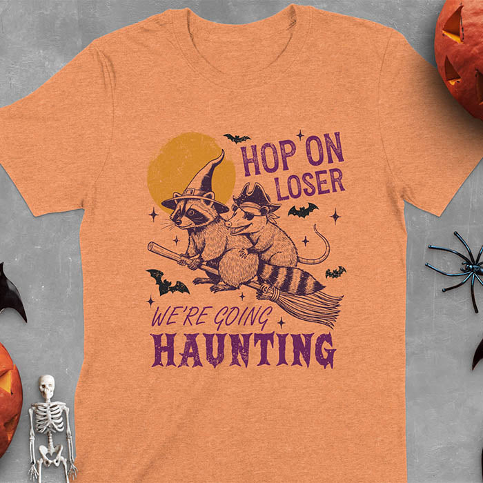 Heather orange Halloween witch raccoon and opossum t-shirt with flying broom animal graphics