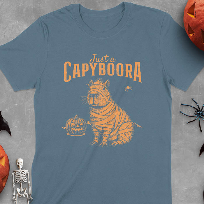 Indigo Blue t-shirt with a Halloween mummy capyboora t-shirt featuring cute capybara wrapped in white bandages with spooky Halloween design