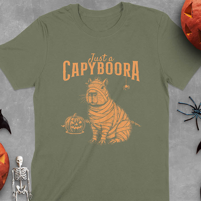Military Green t-shirt with a Halloween mummy capyboora t-shirt featuring cute capybara wrapped in white bandages with spooky Halloween design