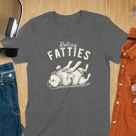 Dark heather t-shirt with 'Rolling Fatties' text and illustration of chubby pitbull dog lying on its back with paws up, with human hands on the dog's belly
