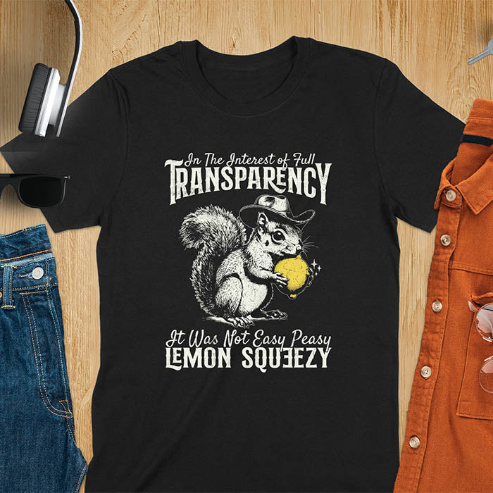 Black t-shirt featuring illustrated squirrel wearing cowboy hat and holding yellow lemon with text 'In The Interest of Full Transparency It Was Not Easy Peasy Lemon Squeezy' - funny sarcastic meme design