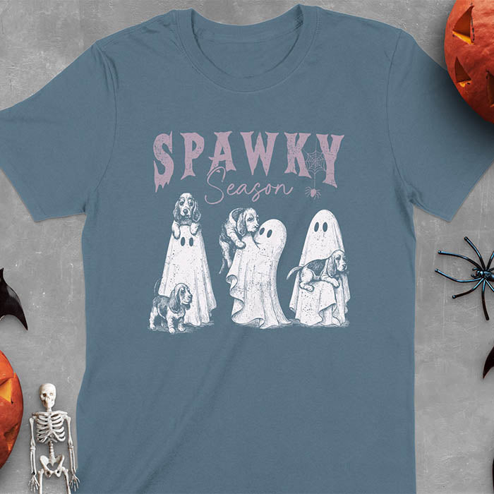 Indigo Blue Halloween T-shirt featuring 'SPAWKY Season' text with cute white ghosts carrying Basset Hound puppies, designed in purple ink with playful Halloween theme