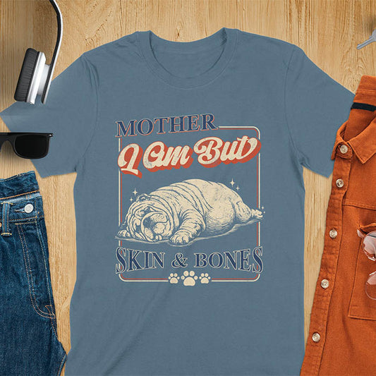 Mother I Am But Skin And Bones text with dramatic sprawled bulldog in pitiful starving pose with vintage retro frame graphic on indigo blue t-shirt