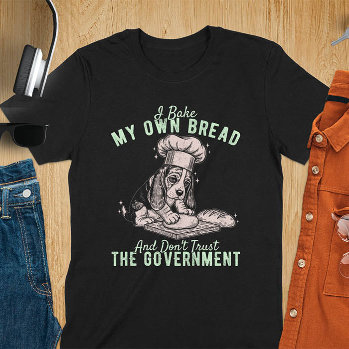 Black Basset Hound chef t-shirt with text 'I Bake MY OWN BREAD And Don't Trust THE GOVERNMENT' featuring basset puppy in chef's hat