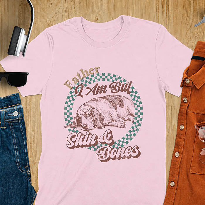 Light pink shirt with Basset Hound graphic, retro checkered design and "Father I Am But Skin And Bones" text