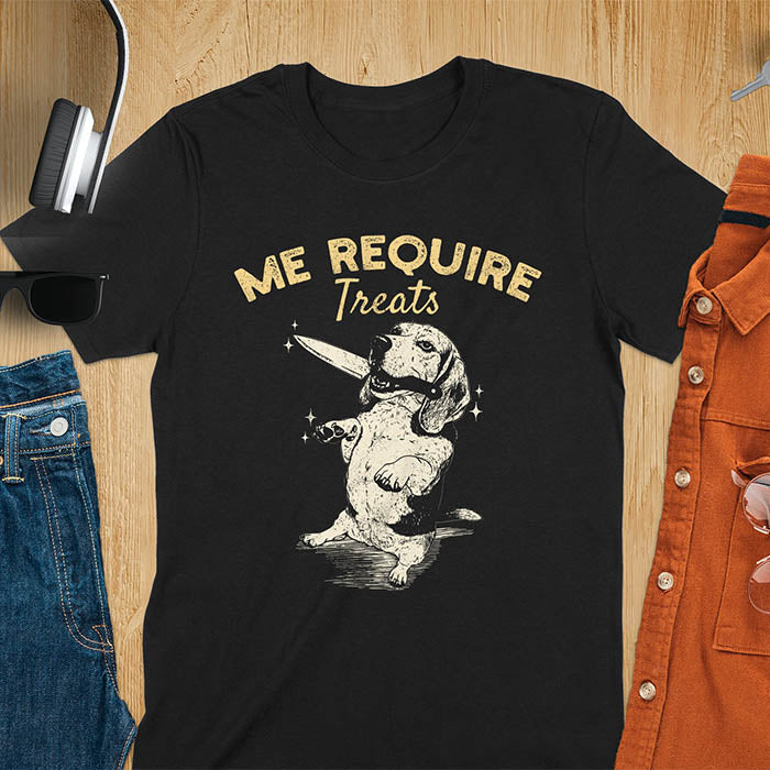 Black t-shirt with Me Require Treats text, basset hound meme design, and vintage grumpy dog biting on a knife in its mouth illustration