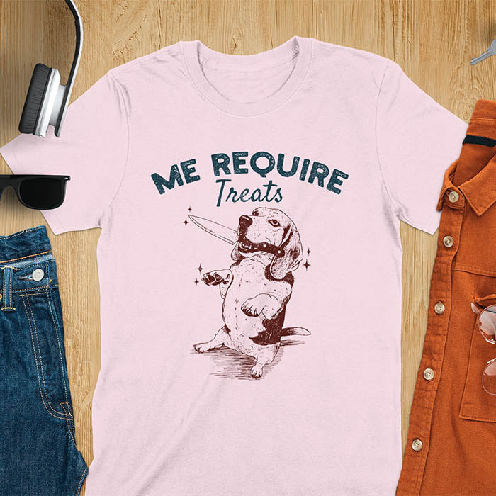 Light pink t-shirt with Me Require Treats text, basset hound meme design, and vintage grumpy dog biting on a knife in its mouth illustration