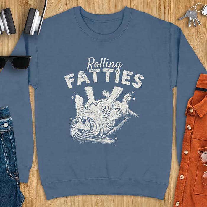 Indigo Blue sweatshirt with a graphic of a basset hound lying on its back while a pair of hands knead its rolled up folds like dough and the text Rolling Fatties