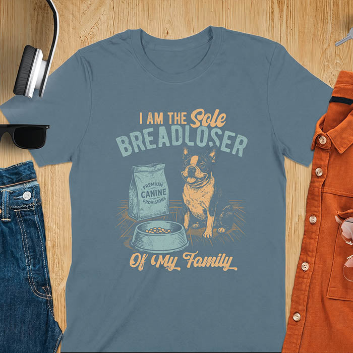 Indigo Blue t-shirt with a vintage illustration of a Boston Terrier sitting beside a bag of dog food and a half-emptied bowl, printed with the text I Am The Sole Breadloser Of My Family.