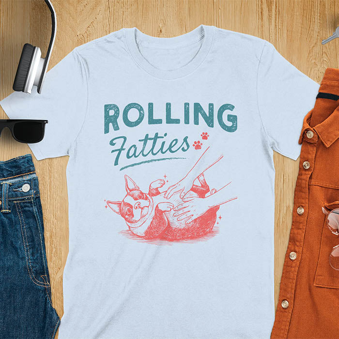 Light blue tee with vintage "Rolling Fatties" text and Boston Terrier rolling on back getting belly rubs graphic