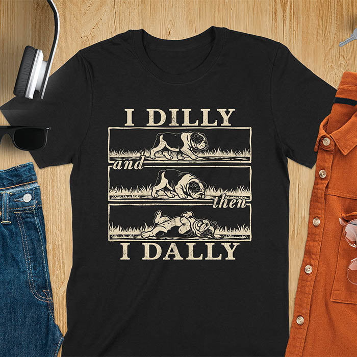 Black t-shirt with vintage comic strip graphic of a bulldog walking, rolling, then lying belly-up with text I Dilly and then I Dally