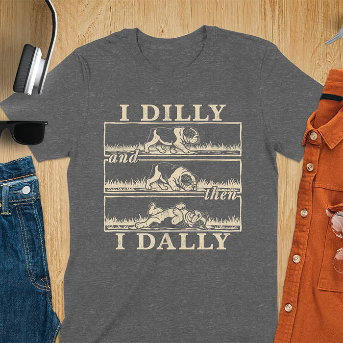 Dark Heather t-shirt with vintage comic strip graphic of a bulldog walking, rolling, then lying belly-up with text I Dilly and then I Dally