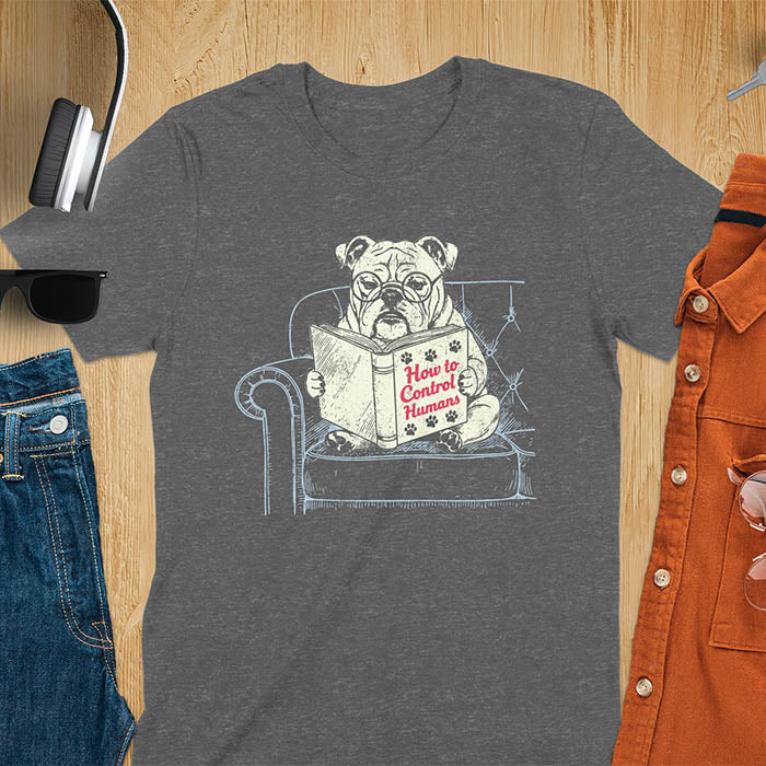 Dark heather t-shirt with vintage bulldog illustration reading 'How to Control Human' book on couch - retro graphic design with humor
