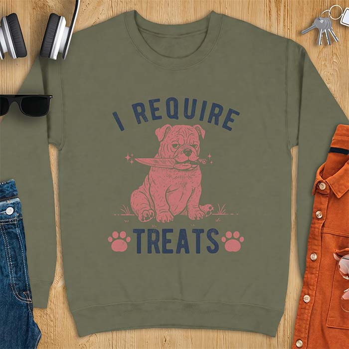 Military Green sweatshirt with a graphic of a deadpan English Bulldog puppy sitting in grass holding a knife in its mouth, with the text I Require Treats and two paw prints