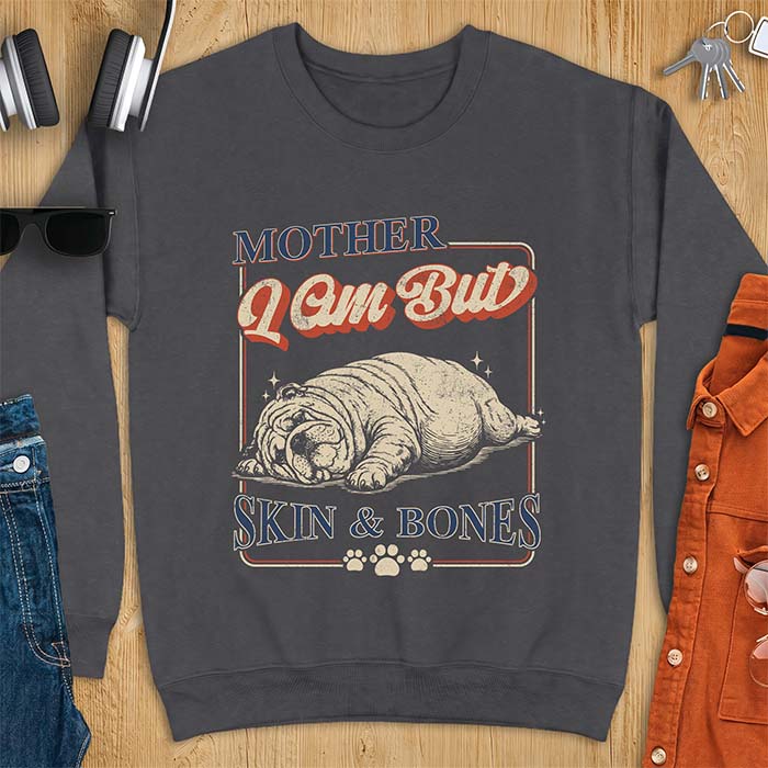 Dark Heather sweatshirt with a graphic of an English Bulldog sprawled flat and exhausted, small sparkles floating near its head and the text Mother I Am But Skin & Bones