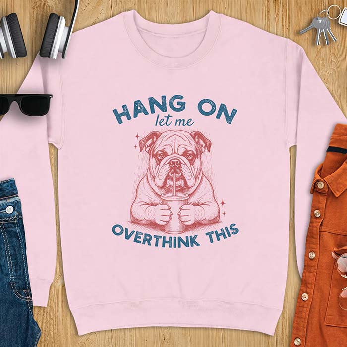 Light Pink sweatshirt with a graphic of an English Bulldog holding an iced coffee with a straw, with the text Hang On Let Me Overthink This