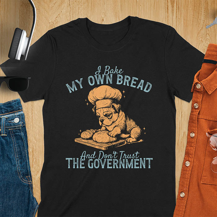 Black tee with "I Bake My Own Bread Don't Trust Government" text and vintage bulldog puppy in chef hat kneading bread graphic