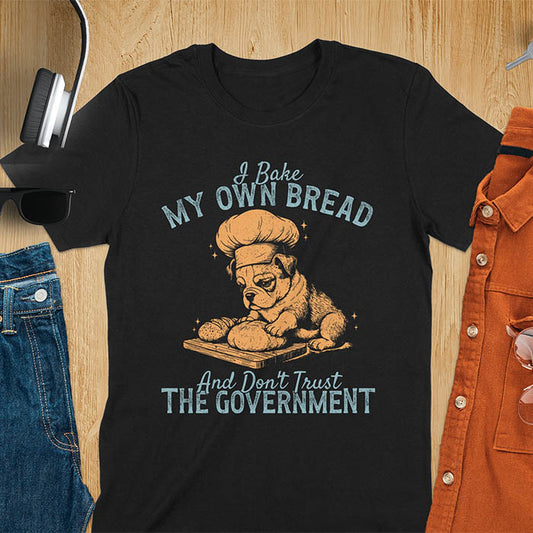 Black tee with "I Bake My Own Bread Don't Trust Government" text and vintage bulldog puppy in chef hat kneading bread graphic