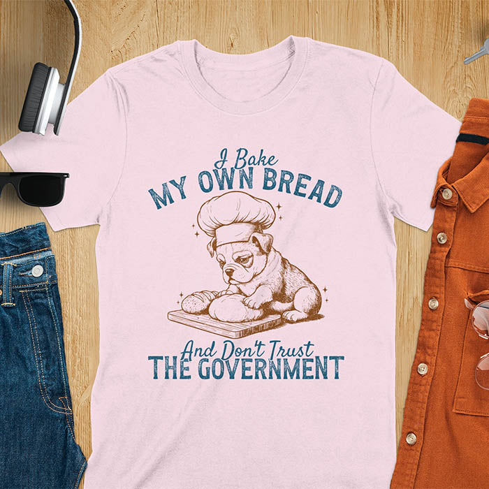 Light Pink tee with "I Bake My Own Bread Don't Trust Government" text and vintage bulldog puppy in chef hat kneading bread graphic