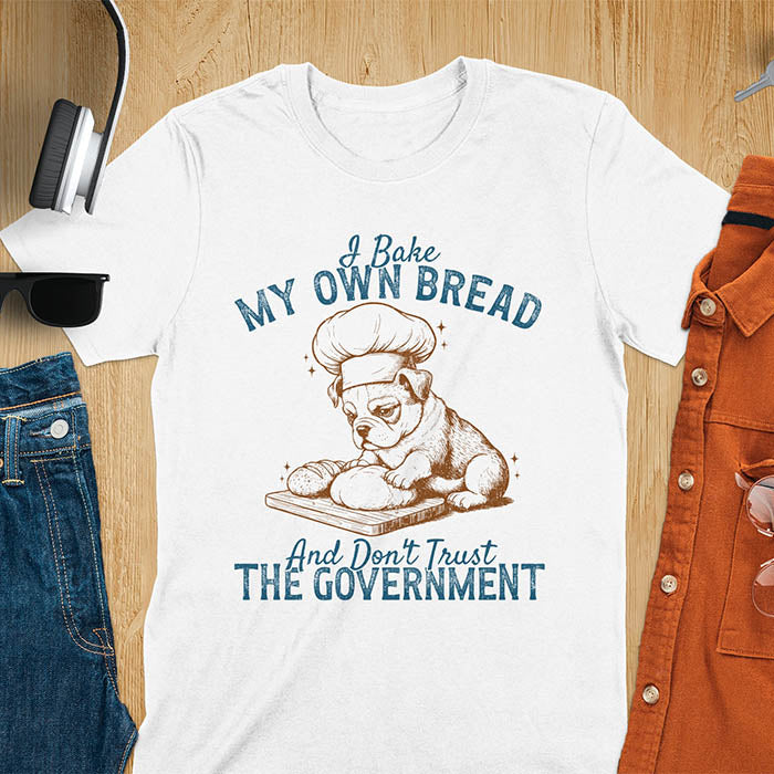 White tee with "I Bake My Own Bread Don't Trust Government" text and vintage bulldog puppy in chef hat kneading bread graphic