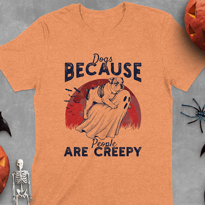 Heather Orange Halloween t-shirt featuring bulldog riding piggyback on ghost with moon background and bats, text reads 'Dogs Because People Are Creepy'