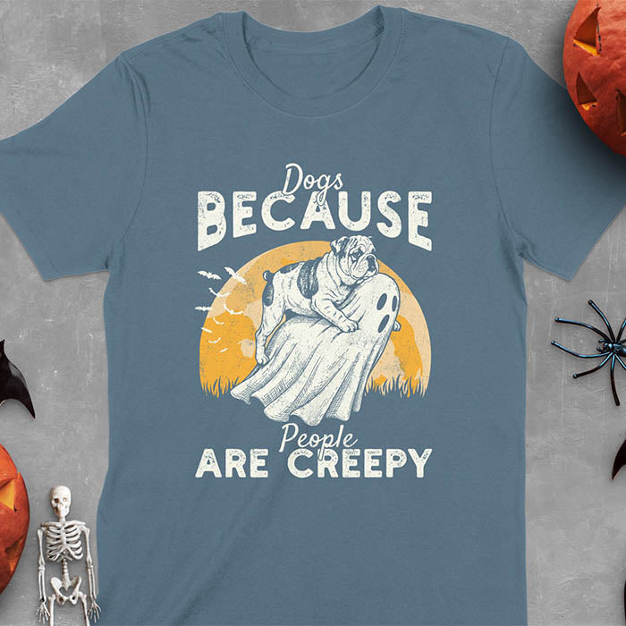 Indigo Blue Halloween t-shirt featuring bulldog riding piggyback on ghost with moon background and bats, text reads 'Dogs Because People Are Creepy'