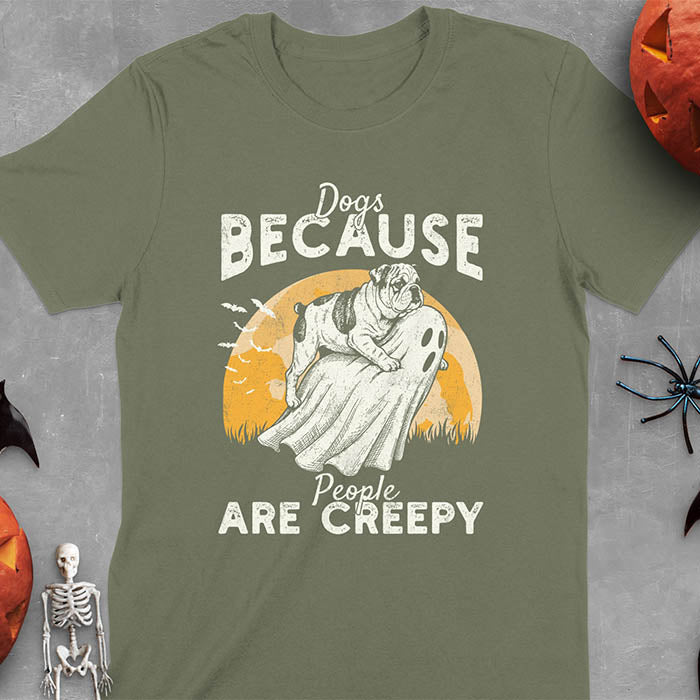 Military Green Halloween t-shirt featuring bulldog riding piggyback on ghost with moon background and bats, text reads 'Dogs Because People Are Creepy'
