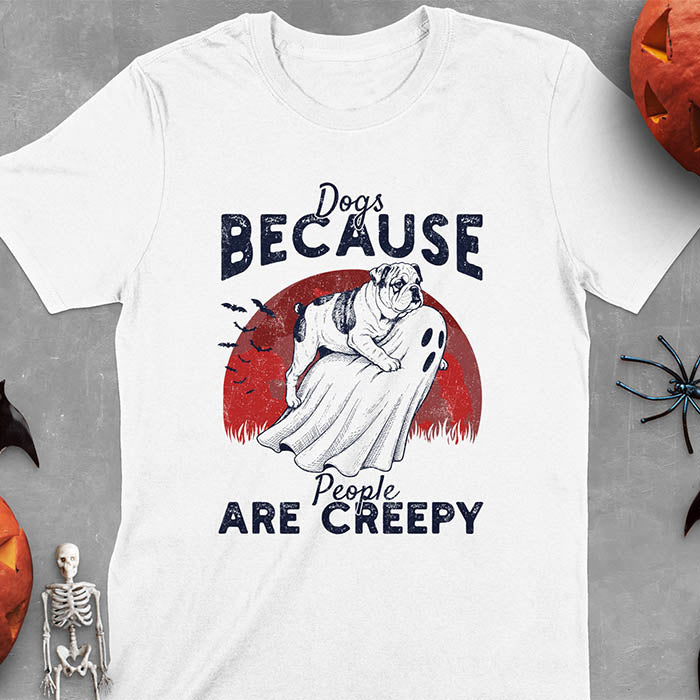 White Halloween t-shirt featuring bulldog riding piggyback on ghost with moon background and bats, text reads 'Dogs Because People Are Creepy'