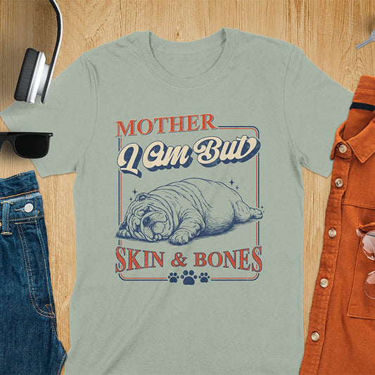 Mother I Am But Skin And Bones text with dramatic sprawled bulldog in pitiful starving pose with vintage retro frame graphic on sage green t-shirt