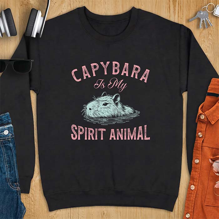 Black sweatshirt with a graphic of a capybara relaxing in water and the text Capybara Is My Spirit Animal