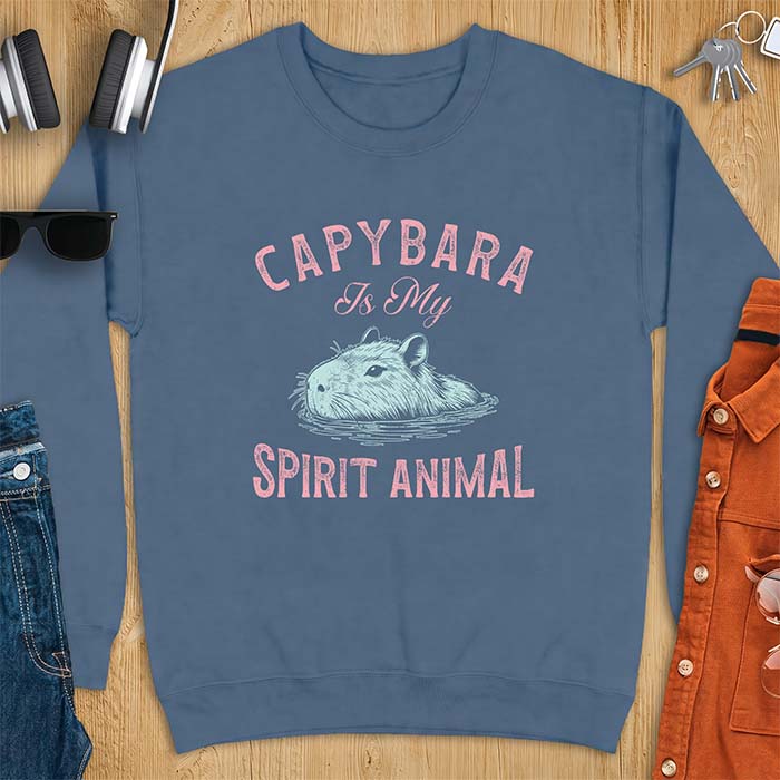 Indigo Blue sweatshirt with a graphic of a capybara relaxing in water and the text Capybara Is My Spirit Animal
