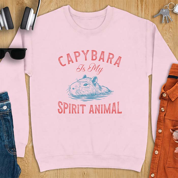 Light Pink sweatshirt with a graphic of a capybara relaxing in water and the text Capybara Is My Spirit Animal