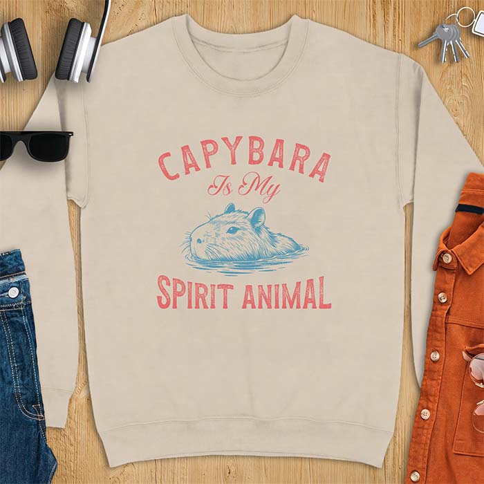 Sand sweatshirt with a graphic of a capybara relaxing in water and the text Capybara Is My Spirit Animal