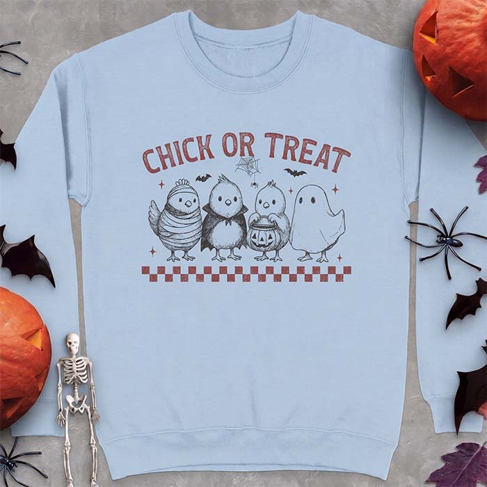 Light Blue sweatshirt with a Halloween graphic of four baby chicks dressed as a mummy, a vampire, a pumpkin bucket trick-or-treater and a ghost, with the text Chick Or Treat