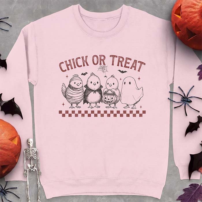 Light Pink sweatshirt with a Halloween graphic of four baby chicks dressed as a mummy, a vampire, a pumpkin bucket trick-or-treater and a ghost, with the text Chick Or Treat