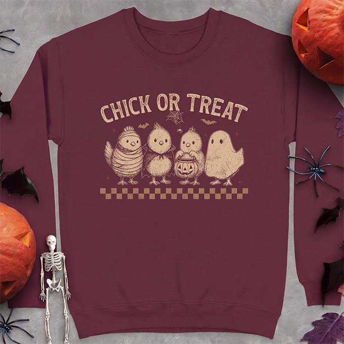 Maroon sweatshirt with a Halloween graphic of four baby chicks dressed as a mummy, a vampire, a pumpkin bucket trick-or-treater and a ghost, with the text Chick Or Treat