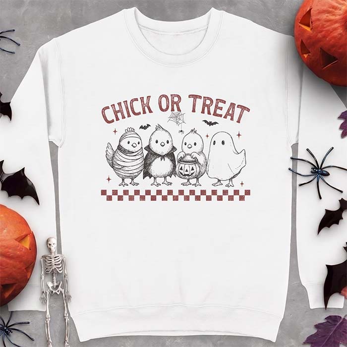 White sweatshirt with a Halloween graphic of four baby chicks dressed as a mummy, a vampire, a pumpkin bucket trick-or-treater and a ghost, with the text Chick Or Treat