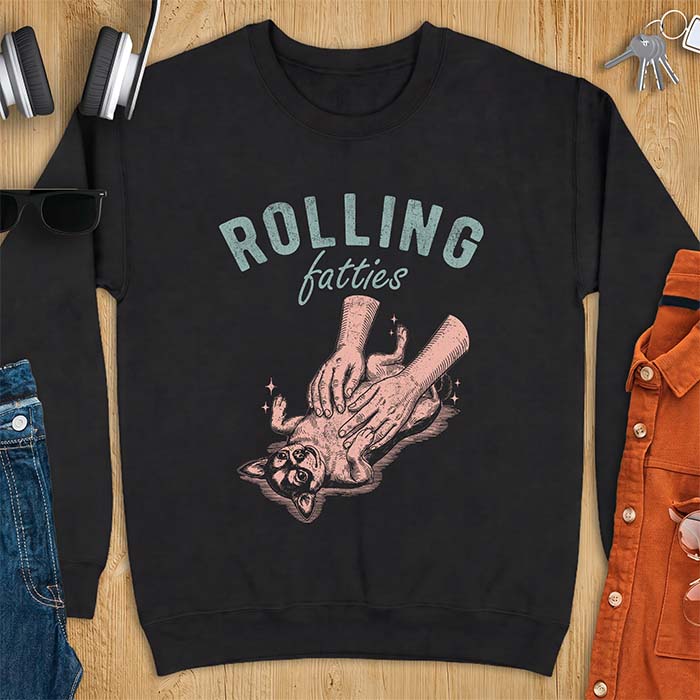 Black sweatshirt with a graphic of a chubby Chihuahua rolled onto its back getting a two-handed belly rub with tiny sparkles around it, above the text Rolling Fatties