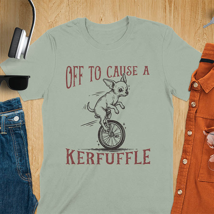 Sage green t-shirt with Chihuahua on unicycle graphic featuring 'Off To Cause A Kerfuffle' text - playful dog meme design