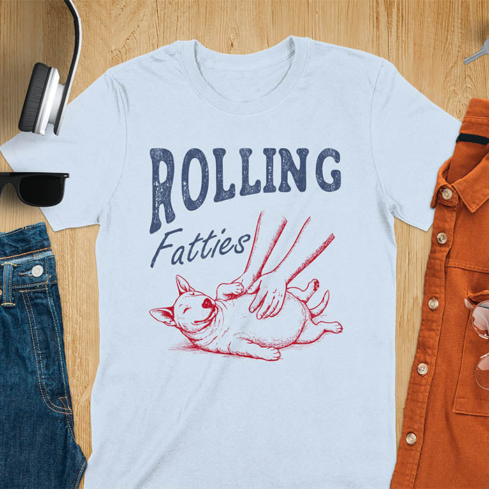Light blue t-shirt with chubby Bull Terrier belly rub graphic featuring 'Rolling Fatties' text, funny dog meme design